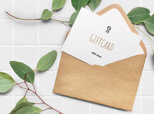 Envelop with paper gift card peeking out, with nudemarket logo and reads "gift card, $100 value."