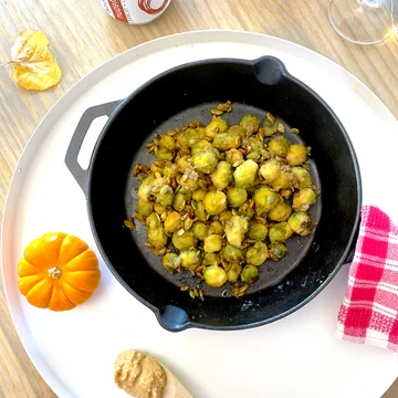 The zero waste trick may be obvious: when carving pumpkins, save the pumpkin seeds! All they need is a quick rinse and you have yourself an incredibly nutrient dense addition to your thanksgiving dinner recipes. We used this hack to add some crunch to the Thanksgiving treat that we are making today: a creamy, savoury and sweet oven roasted brussel sprout recipe. Although this recipe is totally plant-based, the tang from the coconut aminos and Natural Peanut Butter add the same delicious flavour profile that has made adding bacon to brussel sprouts so popular. This version is so so SO delicious! Our additive-free and natural peanut butter melts perfectly into the maple syrup, and the vinegar completes this sauces name, as we like to call it a sweet peanut butter vinaigrette, making these the best roasted brussel sprouts we have ever tasted.